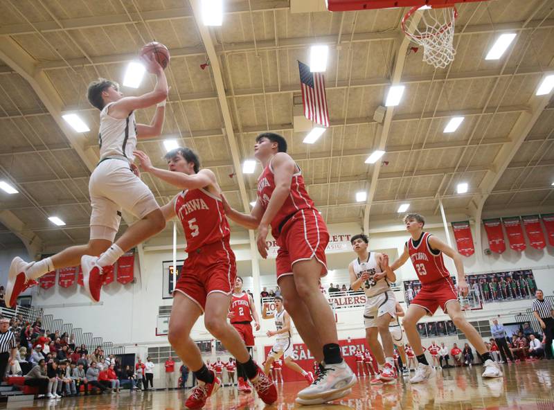 L-P's Seth Adams eyes the hoop while taking a shot over Ottawa's Kyler Araujo and teammate Kooper Knoll on Friday, Jan. 5, 2024 at Sellett Gymnasium.