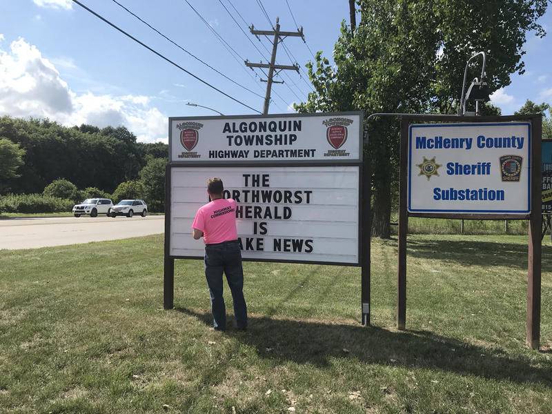 Algonquin Township Highway Commissioner Andrew Gasser corrects a misspelling on the highway department's marquee.