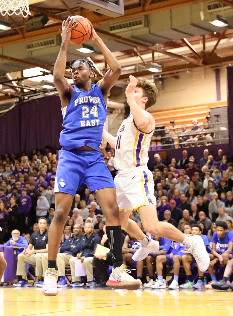 Proviso East's Daye Alexander (24) grabs a rebound during the boys 4A varsity regional final between Downers Grove North and Proviso East in Downers Groves on Friday, Feb. 24, 2023.