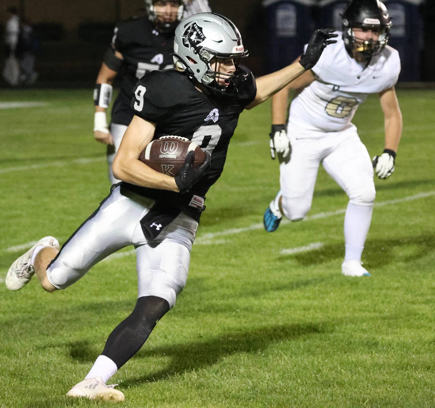 Kaneland's Carter Grabowski carries the ball as Sycamore's Ethan Keicher gives chase during their game Friday, Oct.4, 2024, at Kaneland High School in Maple Park.
