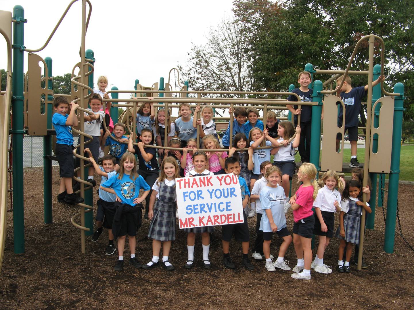 On Tuesday, March 8, 2022,  the eighth grade class at Holy Family School in Shorewood was presented with a flag that was flown over the Pentagon in honor of their dedication to the Honor Flight Program.  As part of the Honor Flight, participants receive letters thanking them for their service.  Six years ago when these were in second grade (pictured above), the students wrote letters to a World War II veteran.  The veteran kept the students’ letters by his bedside until he died in 2021. The same students recently wrote letters again, this time to a Vietnam veteran.