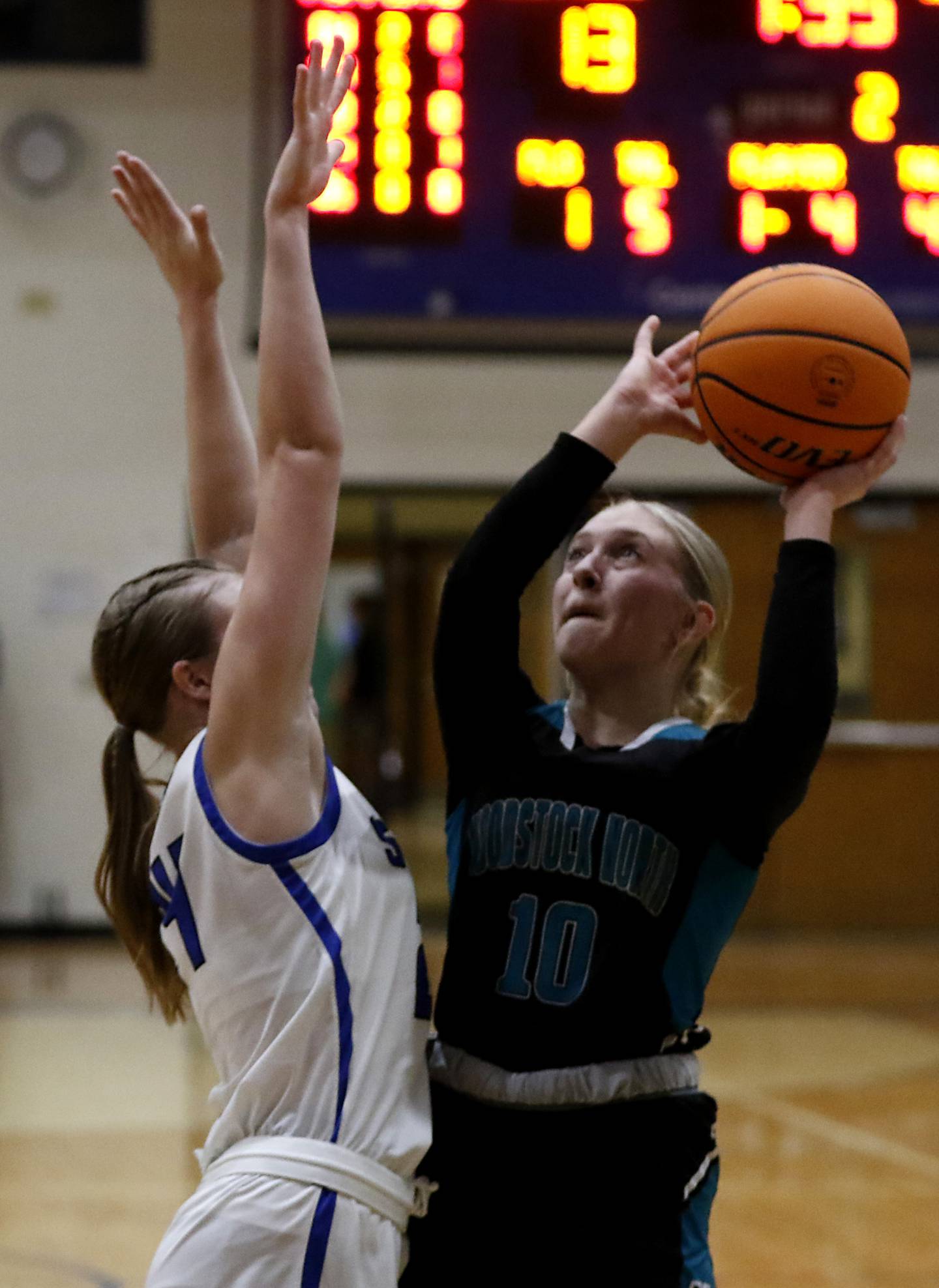 Woodstock North's Madalynn Nordahl (right) tries to shoot the ball over Woodstock's Hayden Williams during a Kishwaukee River Conference basketball game on Friday, Jan. 10, 2025, at Woodstock High School.