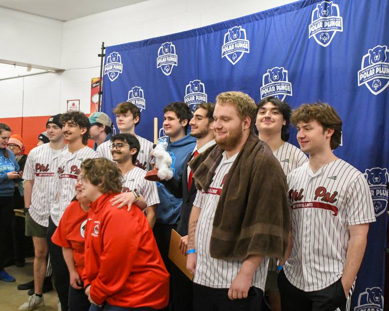 Shelby Edwards and Lisa Steinbis along with members of the Phi Kappa Psi fraternity at NIU pose for a photo before the polar Plunge event on Saturday Feb. 21, 2026, held at Huskie Stadium in DeKalb as they were the winner of the best costume award.