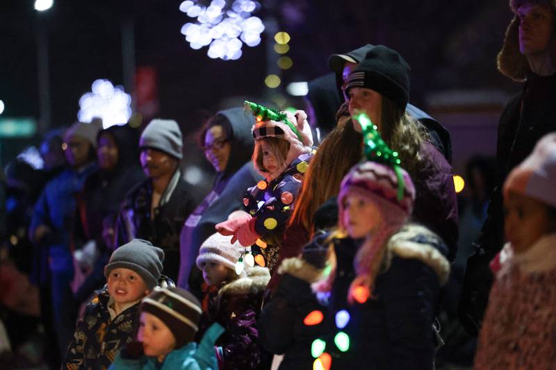 Faye Lowman, 2, of St. Anne, is held for a better view alongside her cousins during the 40th annual Bradley Christmas Parade on Friday, Dec. 5, 2025.