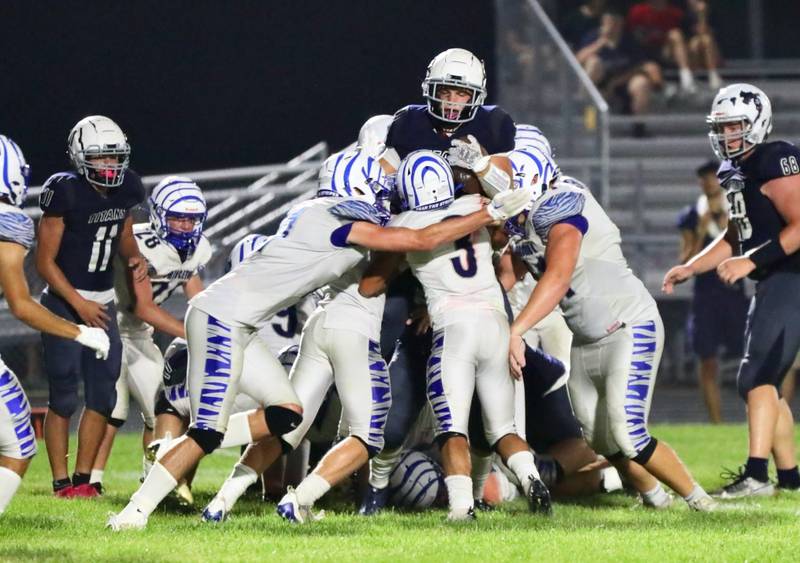 The Tigers gang up on a Monmouth-Roseville ball carrier Friday night. Princeton won 40-0.