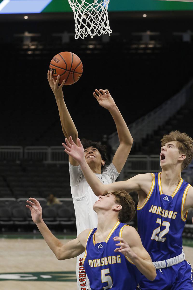 McHenry's Carter Sites, left, grabs a rebound over Johnsburg's Kyle Patterson, center, and Gavin Groves, right. during a non-conference basketball game Sunday, Nov. 27, 2022, between Johnsburg and McHenry at Fiserv Forum in Milwaukee.