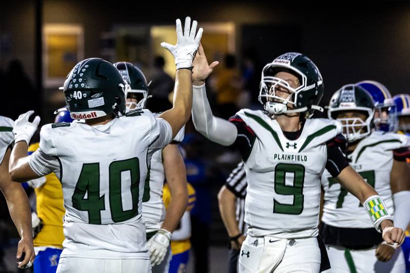 Plainfield Central's Tommy Morrisette gets a high five from Anthony Storck after scoring a touchdown during a varsity football away game against Joliet Central on Sept. 26, 2025.