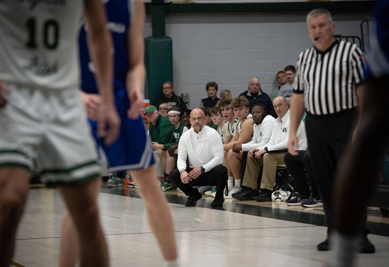Bishop McNamara's head coach Adrian Provost, center, watches the action on the floor against Newark on Friday, Feb. 20, 2026.