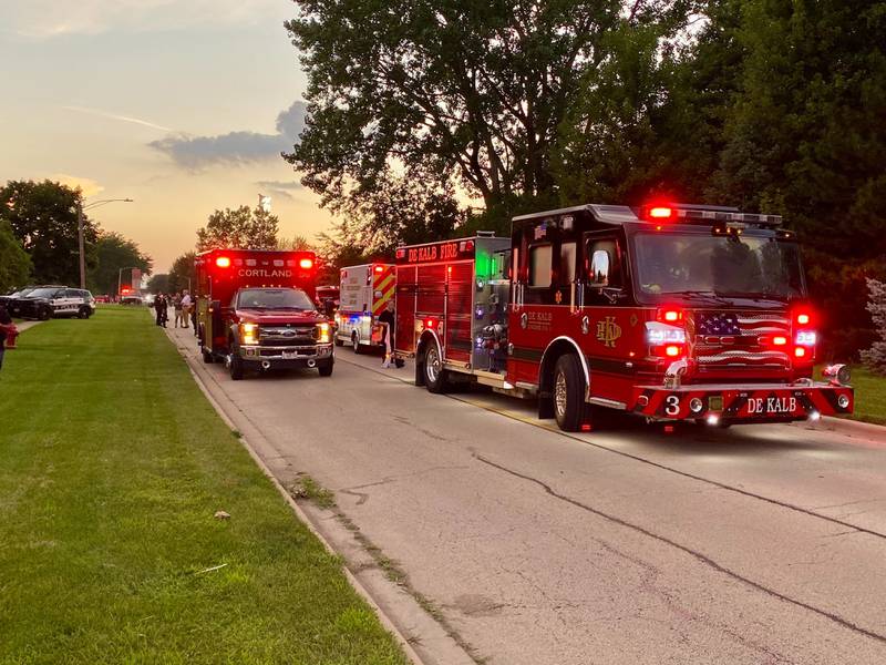 Emergency vehicles from across DeKalb County and northern Illinois line the 600 block of Ridge Drive in DeKalb on Sunday, July 27, 2025, as first responders undertake a water rescue in a nearby retention pond.