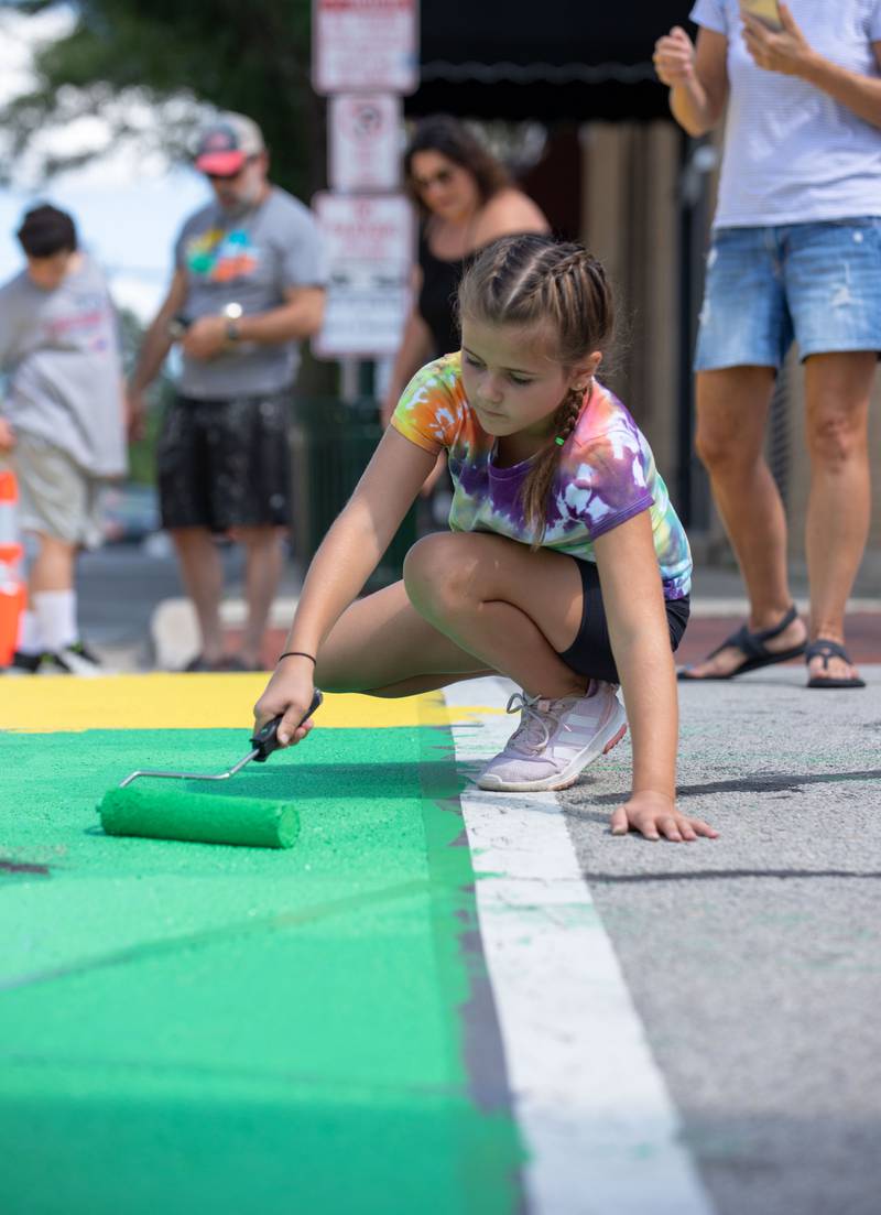 Emery Raiman, 8, of St. Charles paints the intersection of Riverside Avenue and Walnut Street in St. Charles at the Paint the Riverside event hosted by the St. Charles Arts Council on Saturday, July 30, 2022.