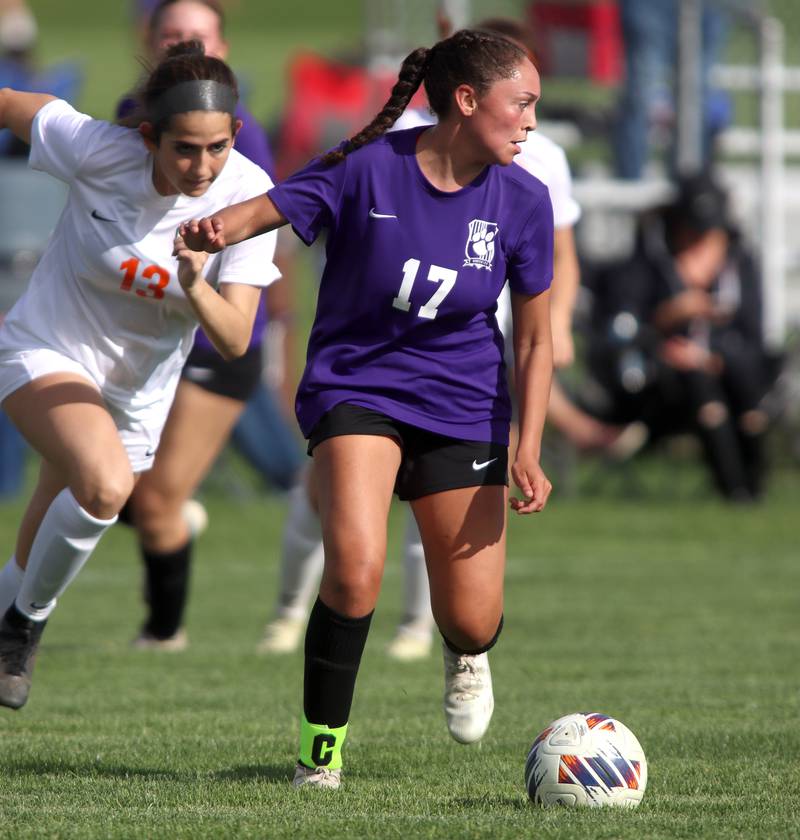 Hampshire’s Helen Negron, right, moves the ball as Crystal Lake Central’s Jordin Gaunaurd pursues the action in varsity soccer at Hampshire Tuesday evening.