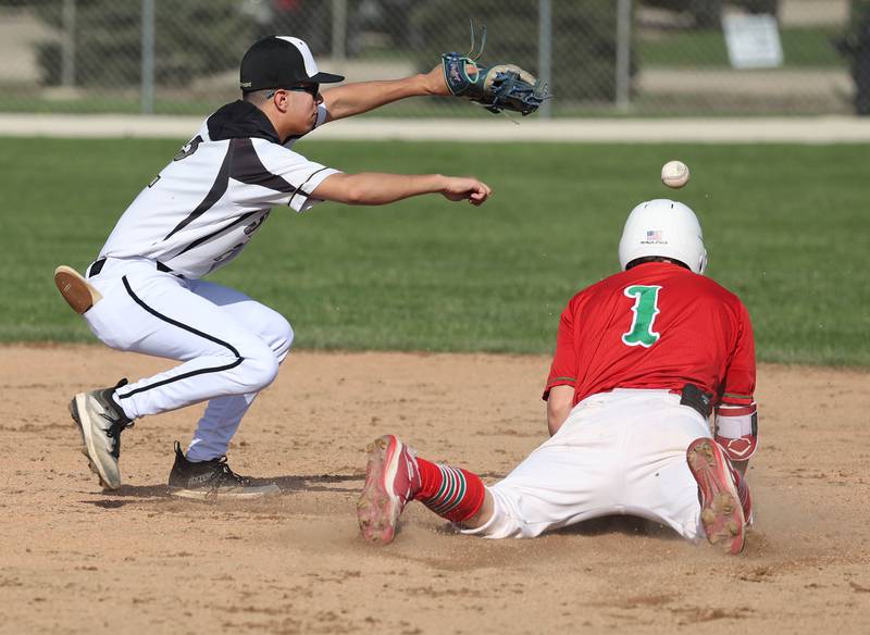 La Salle-Peru's Adrian Arzola slides in with a double as Sycamore's Sawyer Valdez waits for the throw Wednesday, April 23, 2025, during their game at the Sycamore Community Sports Complex.