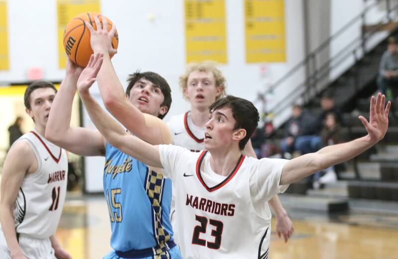 Marquette's Alec Novotney eyes the hoop as Woodland's Nick Plesko guards the lane during the Tri-County Conference Tournament on Tuesday, Jan. 28. 2025 at Putnam County High School.