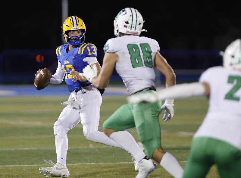 Lyons' Jack Slightom (13) looks downfield for a receiver during the varsity football first-round 8A playoff game between York and Lyons Township on Friday, Oct. 31, 2025 in Western Springs, IL.