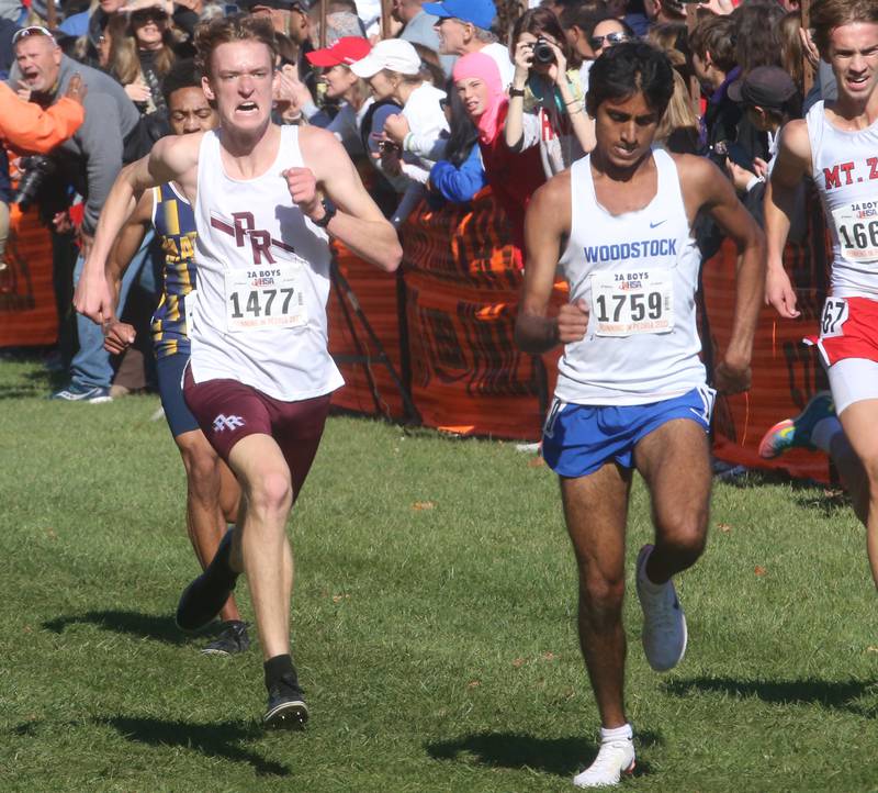 Prairie Ridge's Will Gelon and Woodstock's Ishan Patel compete in the Class 2A State Cross Country race on Saturday, Nov. 4, 2023 at Detweiller Park in Peoria.