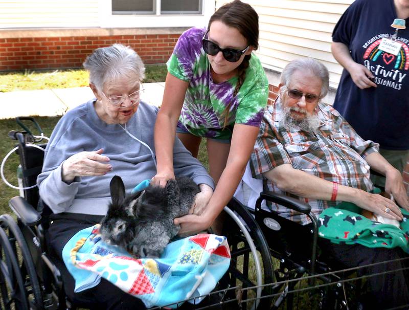 Katie Ford, from Kate’s Kritters Mobile Petting Zoo brings a rabbit to DeKalb County Rehab and Nursing Center resident Jessie Lavender during a petting zoo Thursday, Sept. 18, 2025, at the facility in DeKalb.