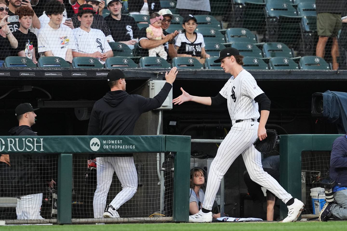 Chicago White Sox starting pitcher Noah Schultz, right, gets a high-five from a teammate as he arrives in the dugout after warming up before a baseball game against the Tampa Bay Rays in Chicago, Tuesday, April 14, 2026. (AP Photo/Nam Y. Huh)