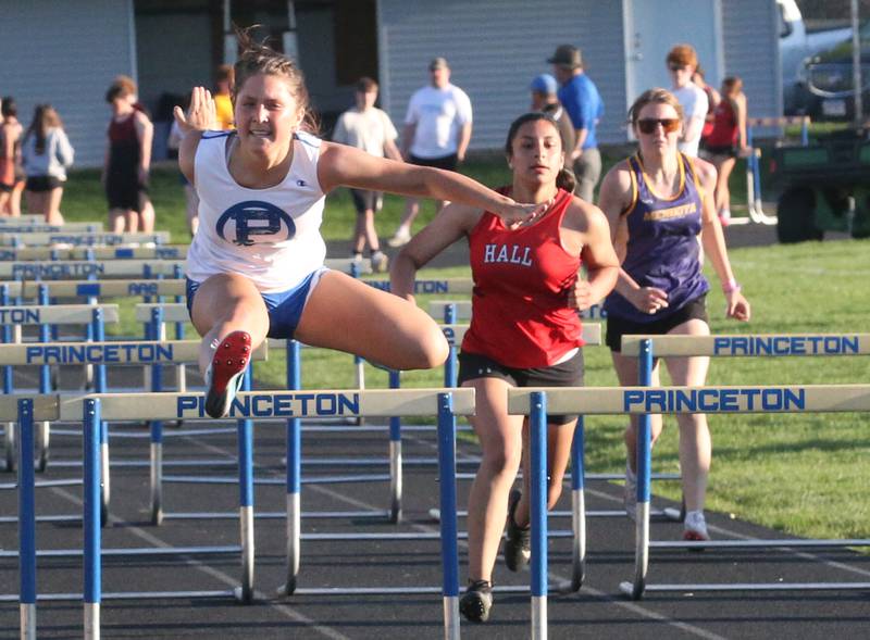 Princeton's Miyah Fox, Hall's Natalia Zamora, and Mendota's Abby Buettner compete in the 110 meter hurdles during the Ferris Invitational on Monday, April 15, 2024 at Princeton High School.