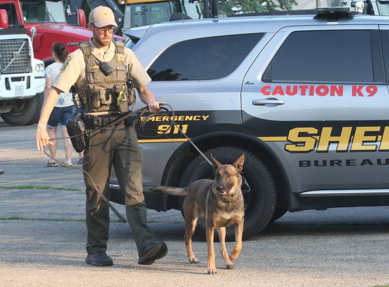 Bureau County Sheriff K-9 handler Kyle Rokey and his partner Alvin conduct K-9 demonstrations during the National Night Out event on Tuesday, Aug. 5, 2025 at Zearing Park in Princeton. The event featured K-9 and drone demonstrations, Mr. Cinnamon balloon twister, face painting, emergency vehicles, and more. National Night Out is an annual community policing campaign held on the first Tuesday of August to create police-community partnerships and build safer neighborhoods.