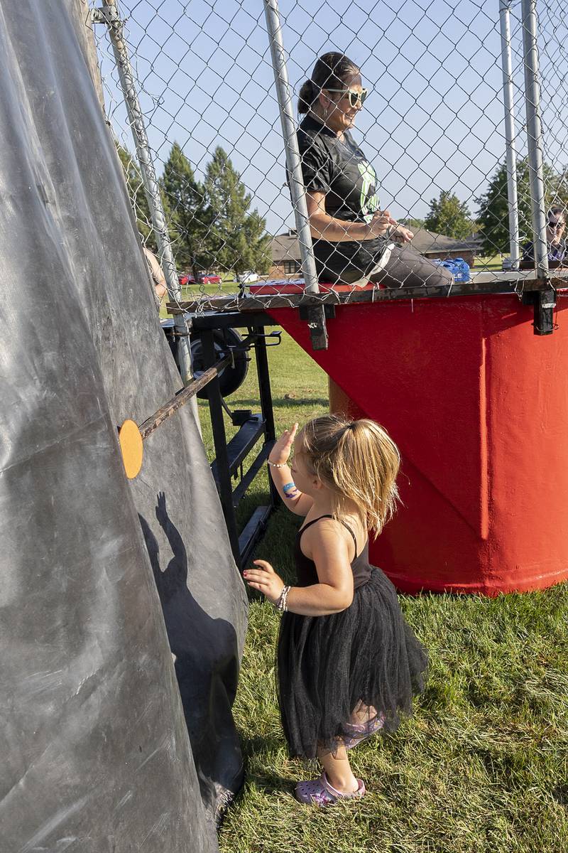 Oaklyn Eich, 4, smacks a lever sinking Crystal Thorpe Thursday, Aug. 29, 2024, at Wooden Wonderland.