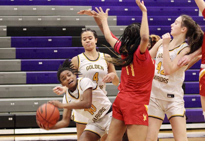 Sterling's Taah Liberty (10) looks to pass after getting caught near the baseline. From left, Sterling's Olivia Turner (4), Rockford Jefferson's Kathryn Rowzee (11) and Sterling's Madison Austin (42). Jefferson beat Sterling 41-37 at the Dixon KSB Holiday Classic on Wednesday.