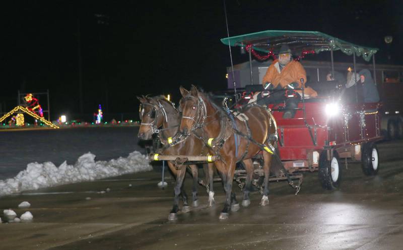 Tony Troyer of Arabian Carriage Co. leads a team of horses through the Christmas lights on Tuesday, Rotary Park on Tuesday, Dec. 9, 2025 in La Salle. Carriage rides are offered in November and December at Rotary Park. The last ride is scheduled for Thursday, Dec. 11. Prices are $25 per person or $200 for the entire wagon up to a dozen people. The carriage rides are organized by the Illinois Valley Chamber of Commerce. For more information visit https://www.ivaced.org/carriage-rides.