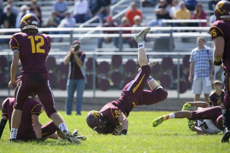 Richmond-Burton fullback Joseph Dittmar (32) is upended after a tackle during the game at Richmond-Burton High School on Saturday, Sept. 19, 2015.