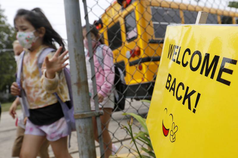 Students are welcomed back to school by staff on their first day back at Landmark Elementary School on Wednesday, July 21, 2021, in McHenry.  The school, which has about 210 students, offers a shortened summer break but extended fall and winter breaks to make the educational process more year-round.