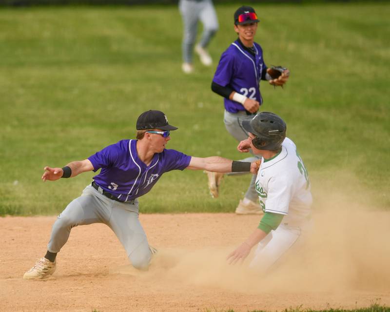 Downers Grove North's Luke Fordonski, left, tags out the base runner Nick Allen of York High School during the game on Monday May 19, 2025, held at York High School in Elmhurst.
