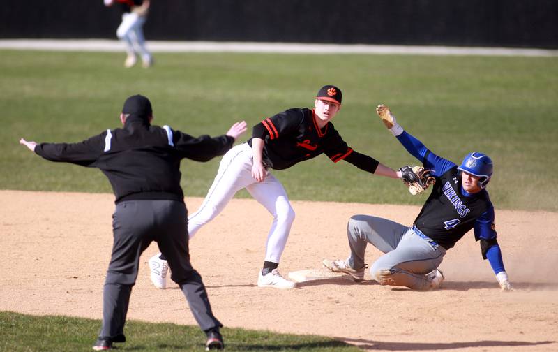Geneva's Ethan Gronberg slides safely into second base under the glove of Wheaton Warrenville South's Blake Snyder during a game on Monday April 14, 2025 in Wheaton.