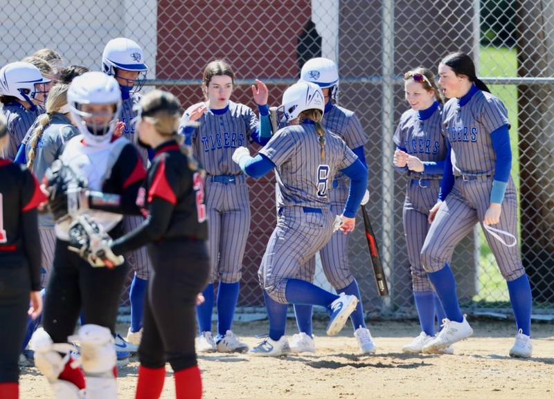 Princeton's Avah Oertel is greeted by all her friends in blue after her home run Saturday at Hall.