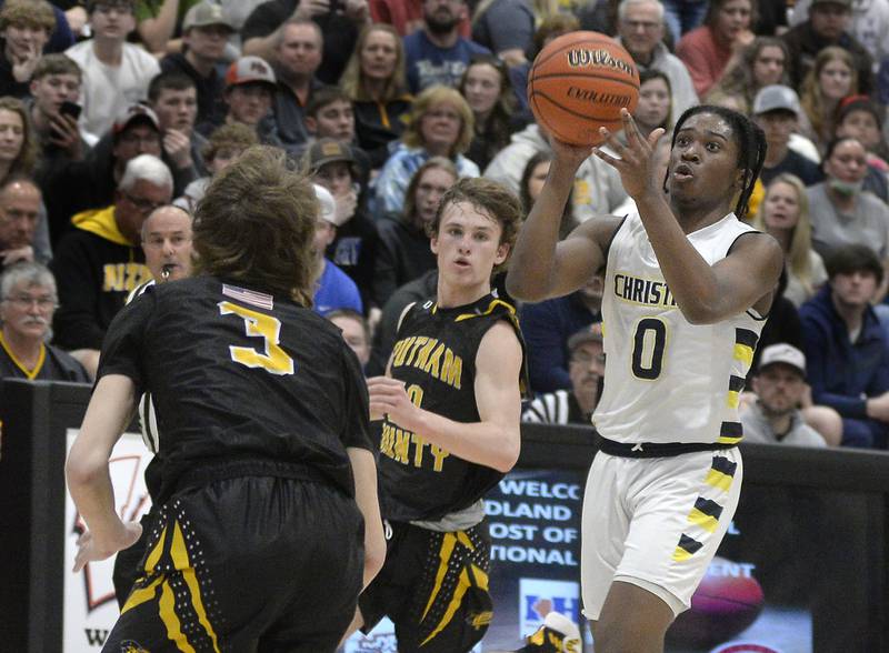 Yorkville Christian’s K.J. Vasser attempts a 3-pointer as Putnam County’s Drake Smith and Austin Mattingly defend Friday, March 4, 2022, at the IHSA sectional at Woodland in rural Streator.