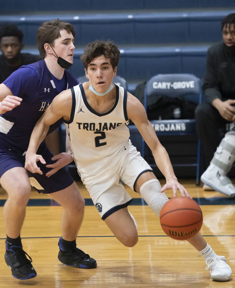 Cary-Grove's John Mau moves past Hampshire defender Sam Ptak during their game on Tuesday, January 25, 2022 at Cary-Grove High School in Cary.