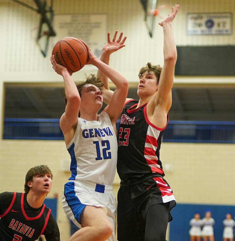 Geneva’s Cole Engebretson (12) drives to the basket against Batavia’s Jax Abalos (23) during a basketball game at Geneva High School on Friday, Dec 15, 2023.