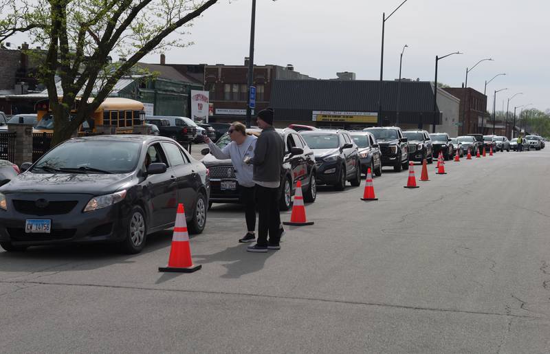 A long line of cars wait in the drive-thru during the Lighted Way Spaghetti Supper on Monday, April 22, 2024 at Uptown Bar and Grill in La Salle.