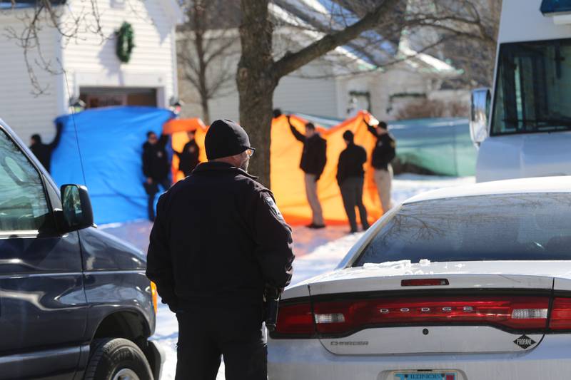 Investigators held up tarps on either side of the driveway of a home in the 200 block of Manchester Lane in Port Barrington, after McHenry County Sheriff's Office deputies shot and killed a person after the person allegedly opened gunfire on a woman and deputies in the early morning hours of Tuesday, Jan. 11, 2022.