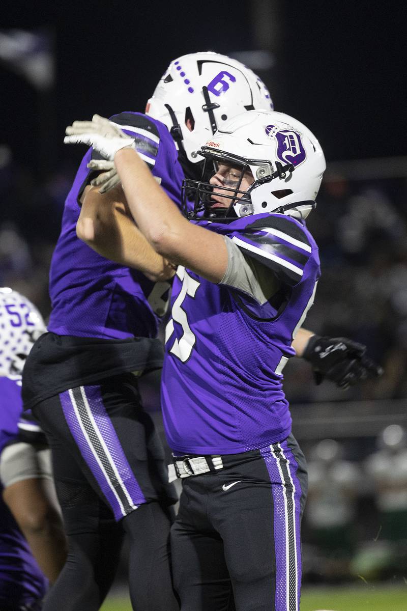 Dixon’s Logan Mershon (left) and Dixon’s Blaine Eberhardt celebrate a fumble recovery against Coal City Friday, Nov. 7, 2025.