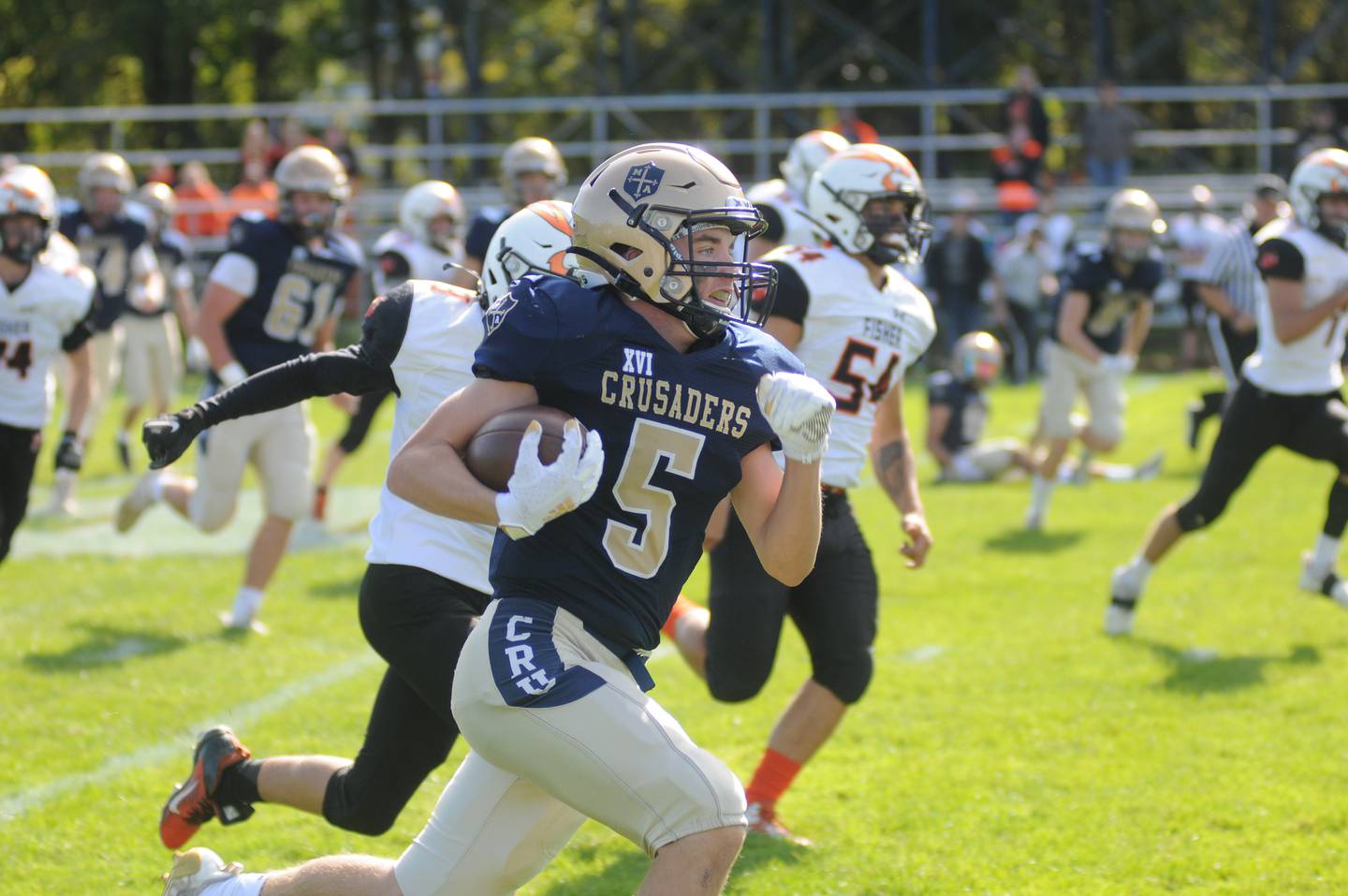 Marquette's Tom Durdan (5) blows past Fisher defenders for a 54-yard first-quarter touchdown, starting the Crusaders toward a 55-14 win Saturday at Gould Stadium.