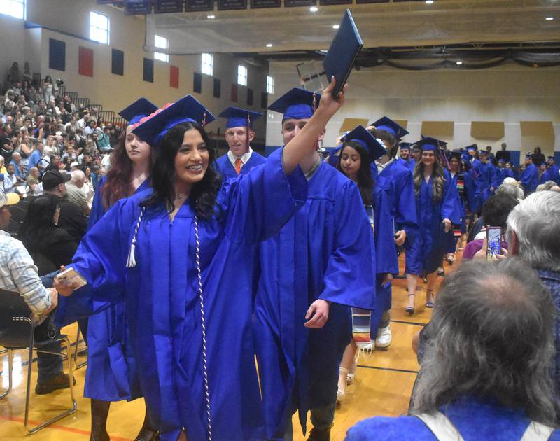 Genoa-Kingston High School graduate Guadalupe Rangel-Martinez shows her diploma to the crowd Saturday, May 17, 2025, during graduation at the school.