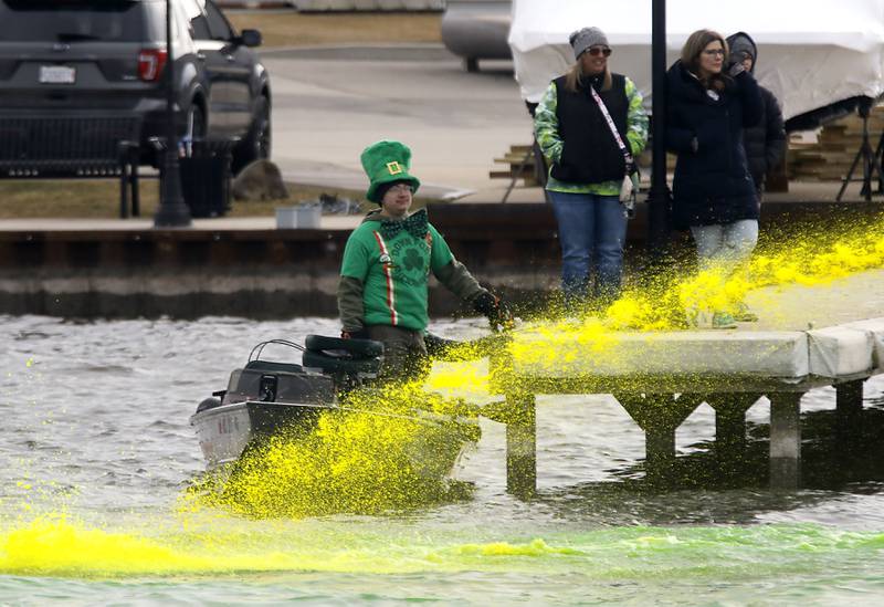 A man dressed as a leprechaun watches as dye  is sprayed into the Fox River to dye the river green during the McHenry’s ShamROCKS the Fox Festival on Saturday, March 14, 2026, in McHenry.
