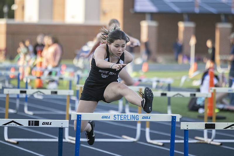 Rock Falls’ Emma Rumley clears a hurdle in the 100 girls shuttle hurdle relays Thursday, April 27, 2023  at the Sterling Night Relays.