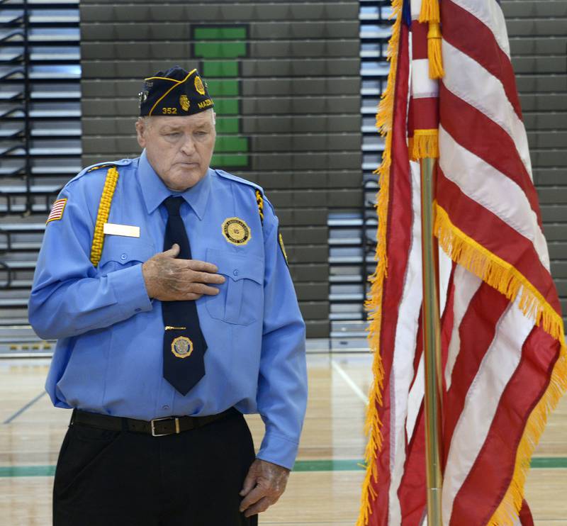 erry Angeloff of American Legion Post 352, turns toward the flag during the Pledge of Alligiance at the Veterans Day ceremony at Seneca High School Monday. The event was sponsored and led by The Seneca FFA.