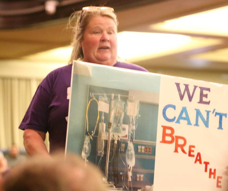 Lisa Hicks, holds a sign saying "We Can't Breathe" during the Carus town hall meeting on Wednesday, May 10, 2023 in Matthiessen Auditorium at LaSalle-Peru Township High School. Her son has had lung health issues ever since the Jan. 11 fire.