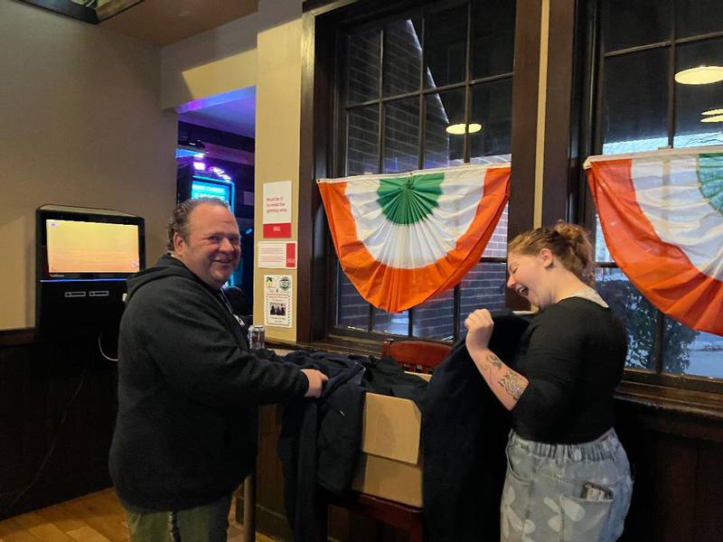 Longtime customer Dave Majury and Durty Nellie's bartender Jessica Schmitt sneak a peek at some new merch that will be available at the gastropub and concert hub starting mid-December. Nellie's — first established in Palatine in 1972 on North Bothwell Street and now at 180 N. Smith St. — is undergoing a retro rebranding, featuring the return of its frog-in-a-beer logo, several classic menu items and nostalgic fan-favorite events.