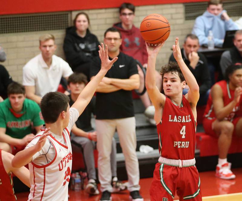 L-P's Jack Jereb shoots a shot over Ottawa's Cooper Knoll in Kingman Gymnasium on Friday, Feb. 10, 2023 at Ottawa High School.
