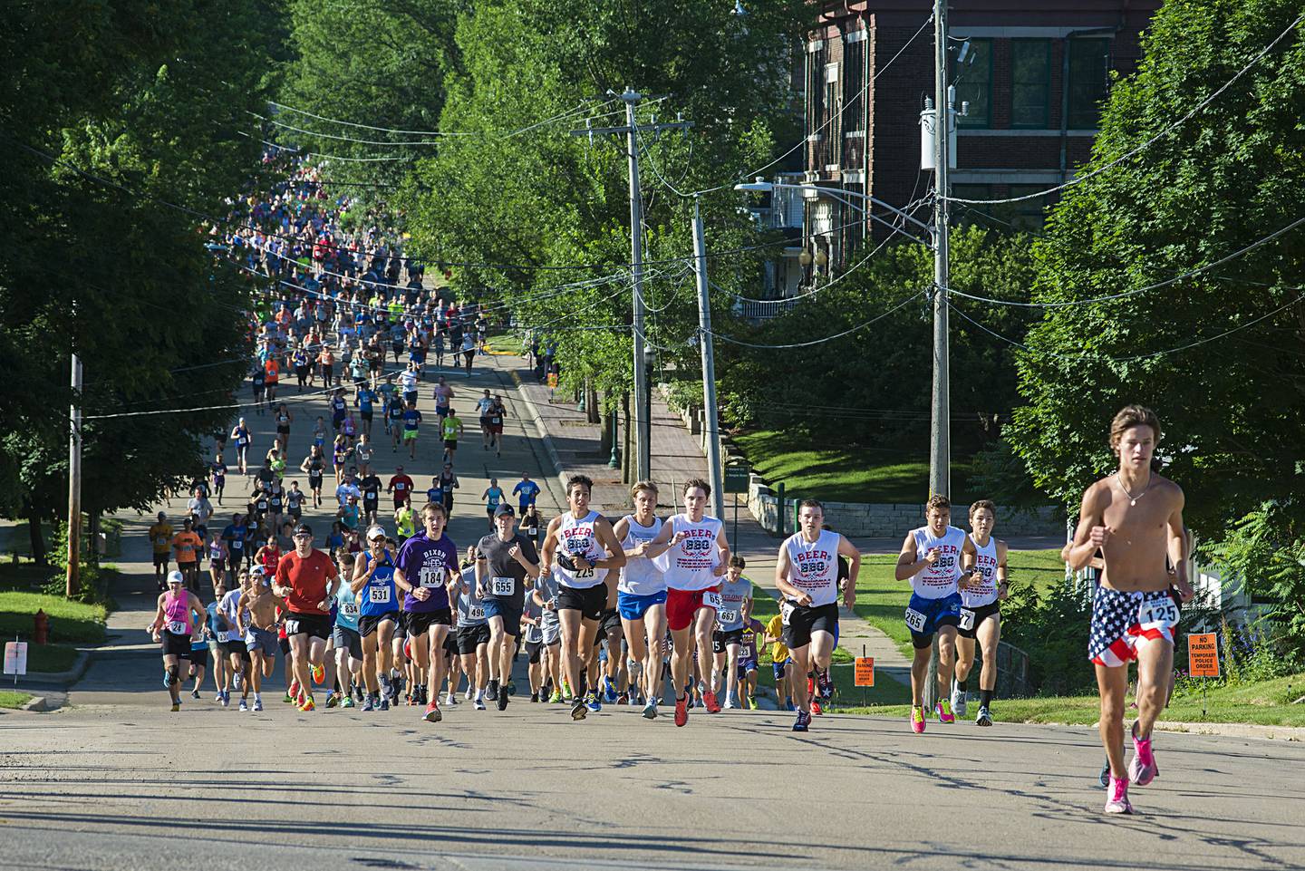 Runners in the 2022 Regan Run head north on Hennepin Avenue near the start of the 5K. The race returned to its original course on Saturday, July 2, 2022 after taking a cover hiatus in 2020 and a different route due to construction in 2021.