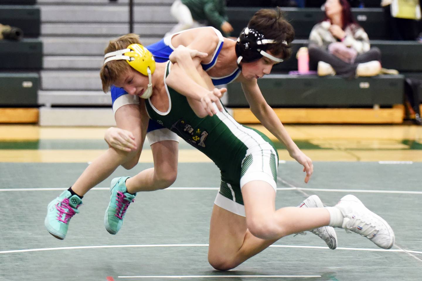 Coal City's Jason Piatak gets Peotone's Jack Vallos off his feet during Thursday's 106-pound match in Coal City.