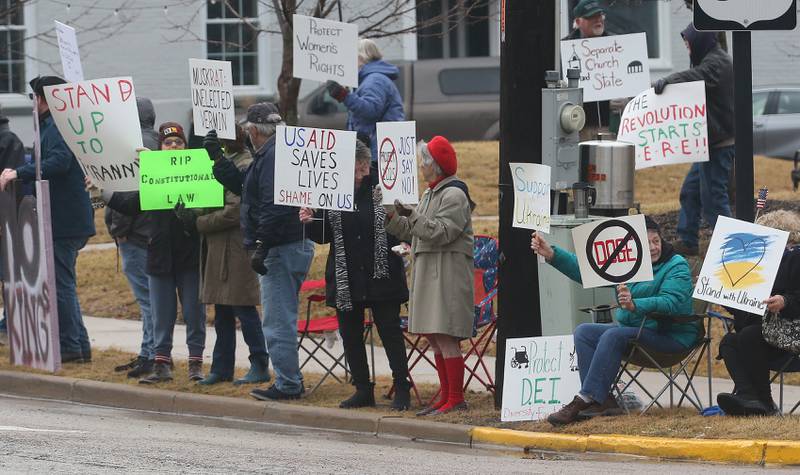 Dozens of citizens gather during a March 4 Democracy on Tuesday, March 4, 2025 at Rotary Park in Princeton. Participants brought signs to feature issues of concern for the county, state and country. The event was sponsored by concerned citizens of Bureau County.