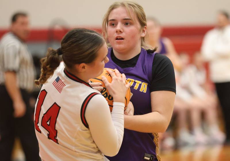 Mendota's Addison Perryman forces a jump ball with Hall's Sophia Simpson on Monday, Dec. 1, 2025 at Hall High School.