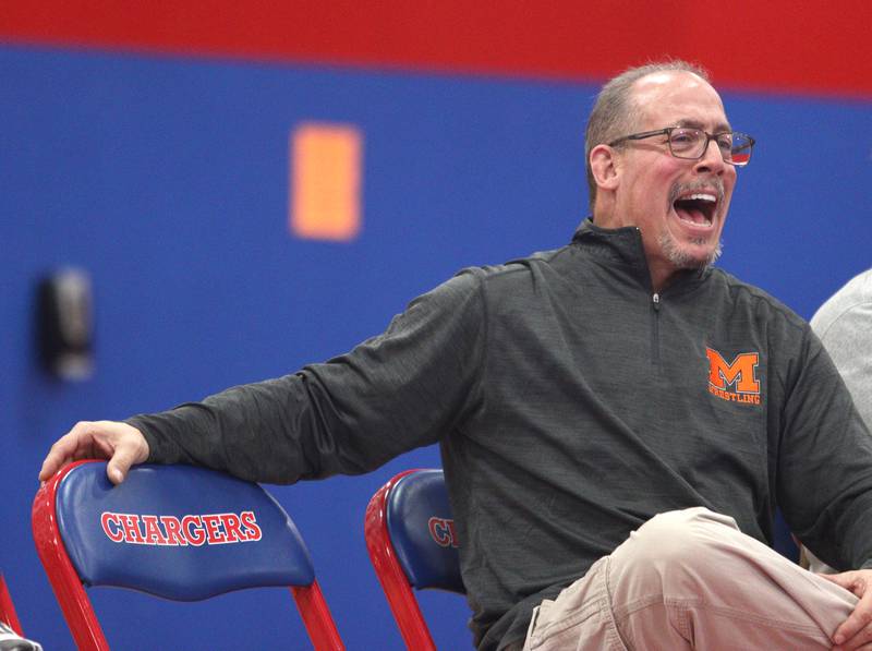 McHenry’s Head Coach Dan Rohman guides the Warriors in varsity wrestling at Carpentersville Thursday night.